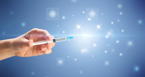 Female doctor hand holding syringe with shiny crosses in the background