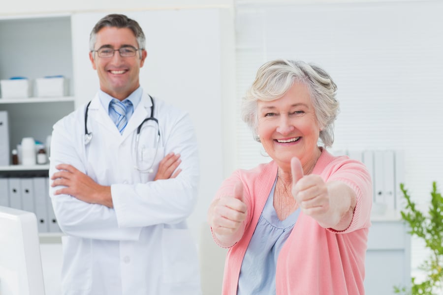 Happy senior citizen woman in a doctors office.