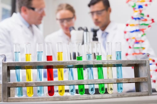 Scientists working attentively with microscope in laboratory