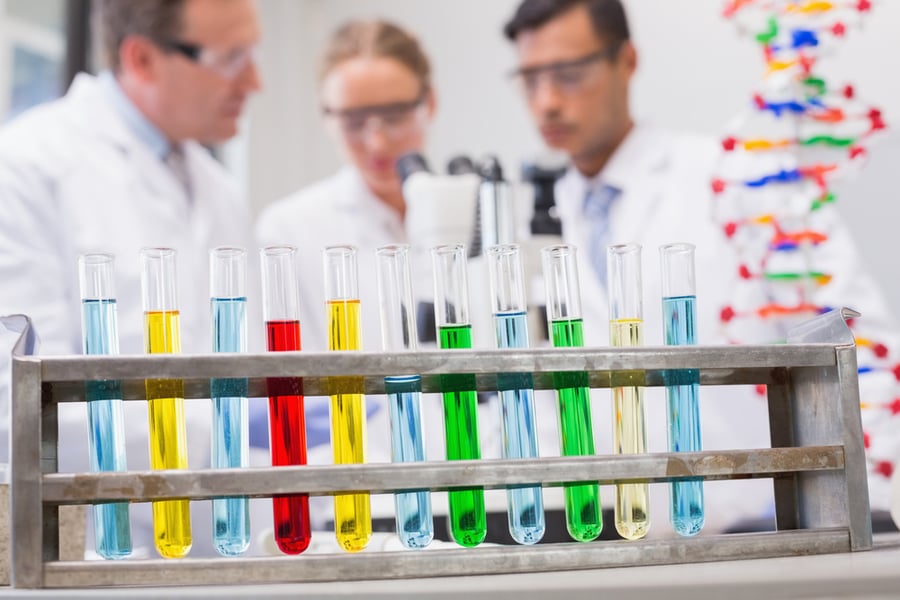 Scientists working attentively with microscope in laboratory