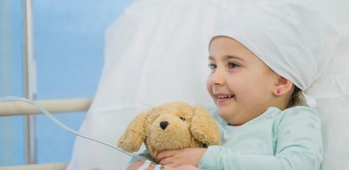 Child with Cancer holding a stuffed animal