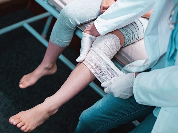 doctor putting a bandage on a wound