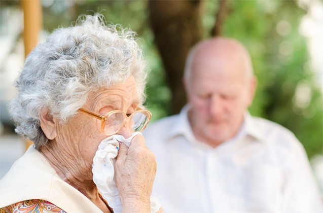 elderly lady blowing her nose