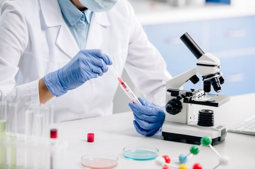 lab technician conducting a blood test in a lab