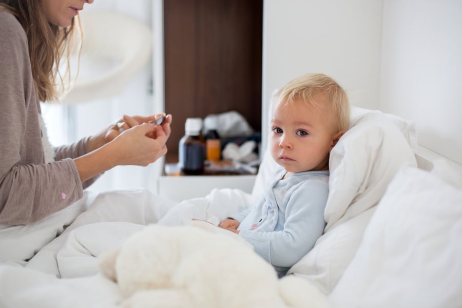 sick child sitting up in bed